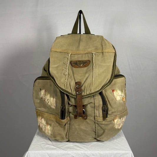 Y2K vintage Diesel distressed canvas backpack in beige and brown tones, featuring slouchy silhouette, large cargo zip pockets, leather strap closure, and embroidered worn-in detailing