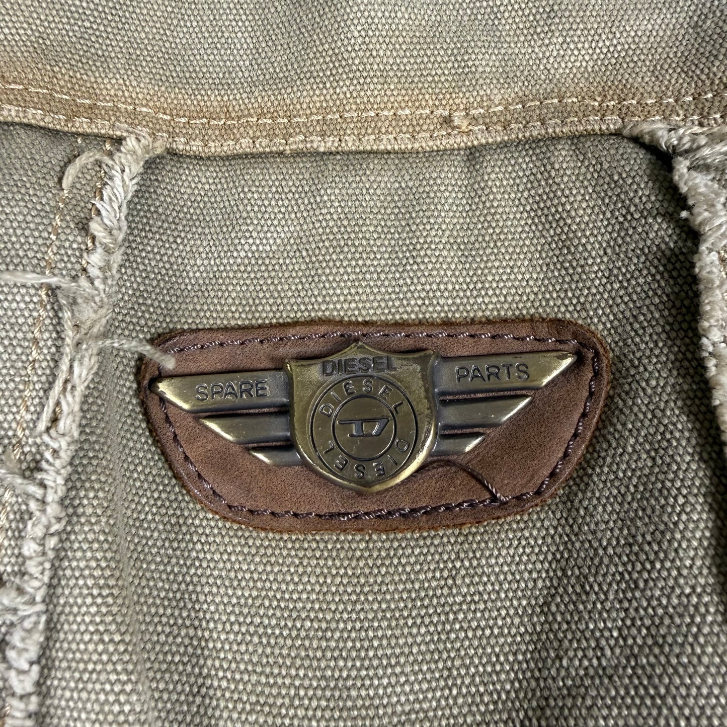 Close-up of a Diesel logo on a textured fabric surface