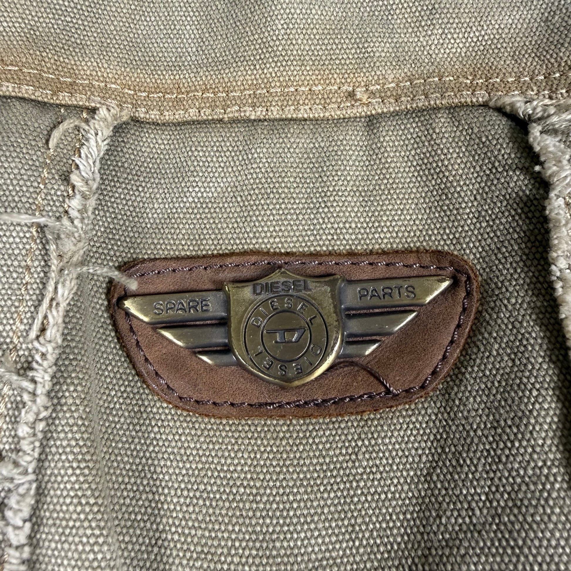 Close-up of a Diesel logo on a textured fabric surface