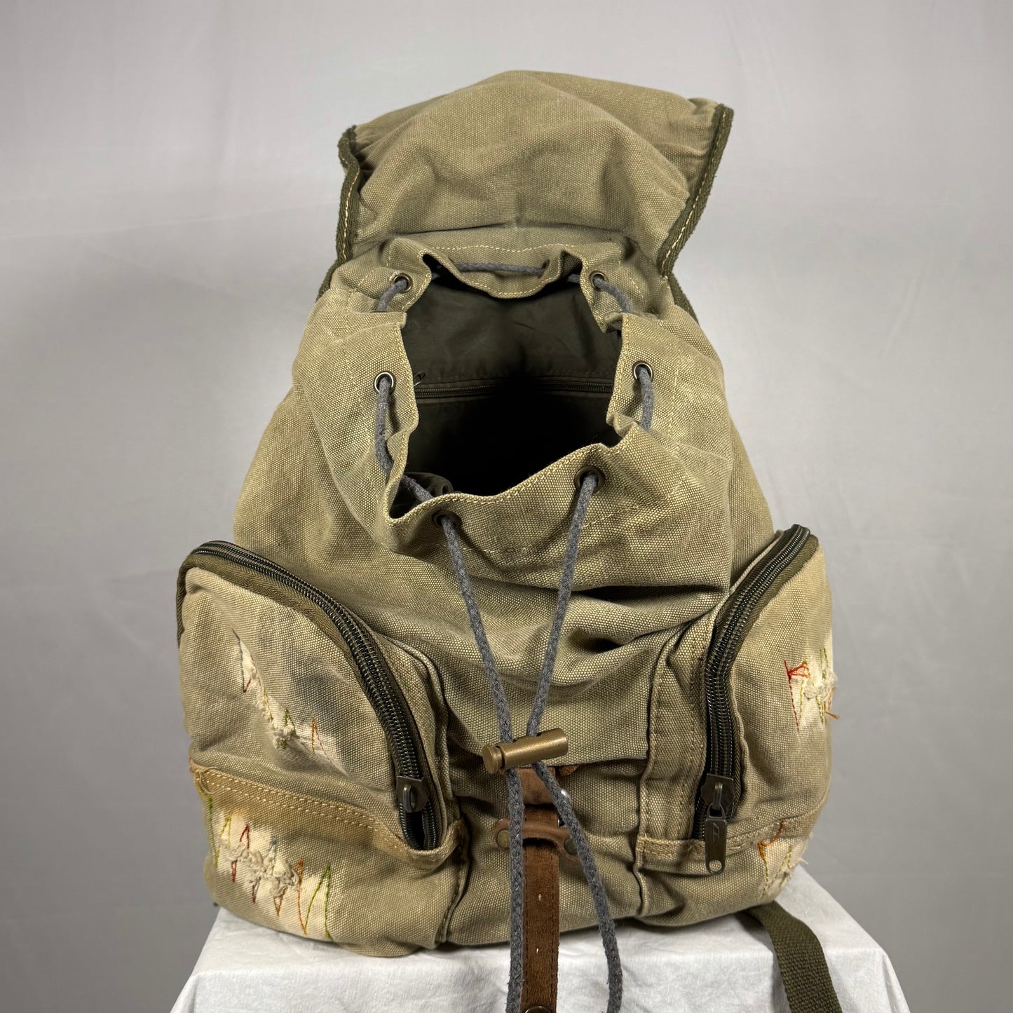 Vintage-style backpack with a hood on a gray background