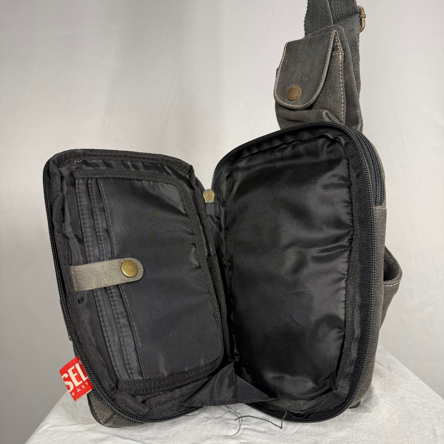 Diesel sling bag fold out interior organizer compartments book style opening