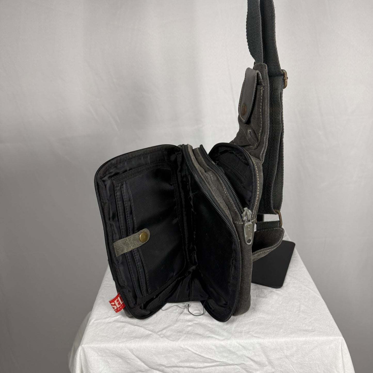 Diesel sling bag fold out interior organizer compartments book style opening