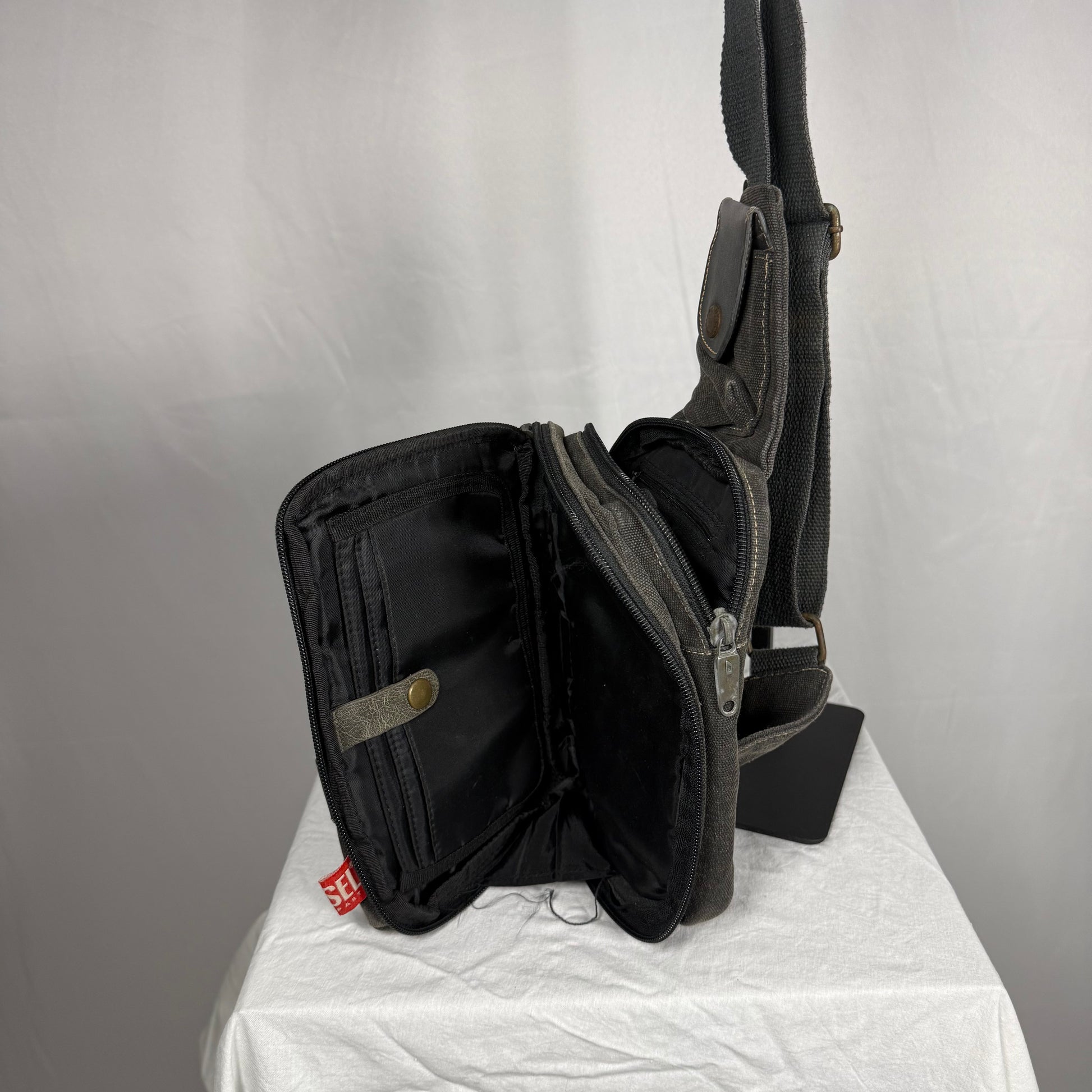Diesel sling bag fold out interior organizer compartments book style opening