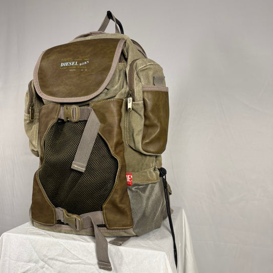 Diesel Y2K vintage utility cargo backpack in olive canvas with brown leather panels, featuring multi pocket design, mesh front panel, and adjustable buckle straps, gorpcore style