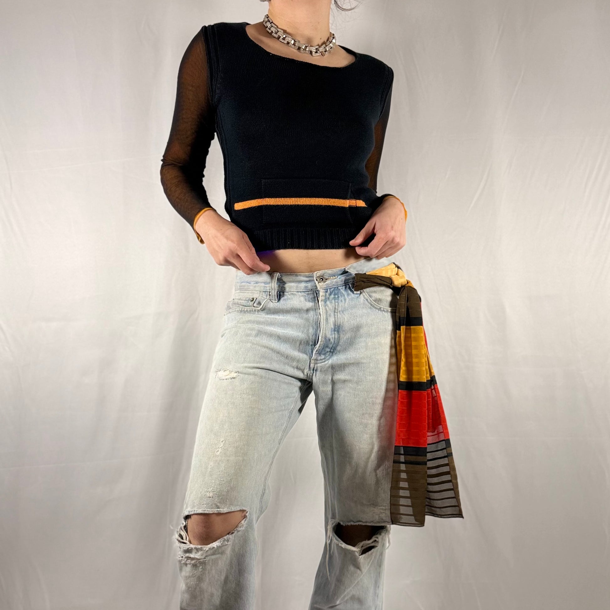 Y2K vintage Cop Copine black knit and sheer mesh long sleeve top with orange contrast trim, cropped silhouette, and layered sleeves