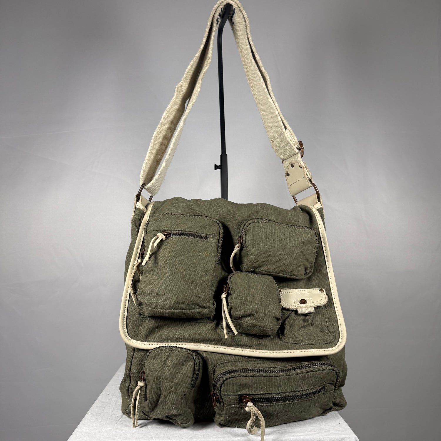 Vintage Y2K Diesel olive linen cargo messenger shoulder bag with cream leather trim, adjustable strap, and multiple utility zip pockets.