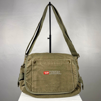 Vintage Diesel olive green heavyweight canvas crossbody bag with embroidered branding, multiple cargo pockets, adjustable shoulder strap and utility details.